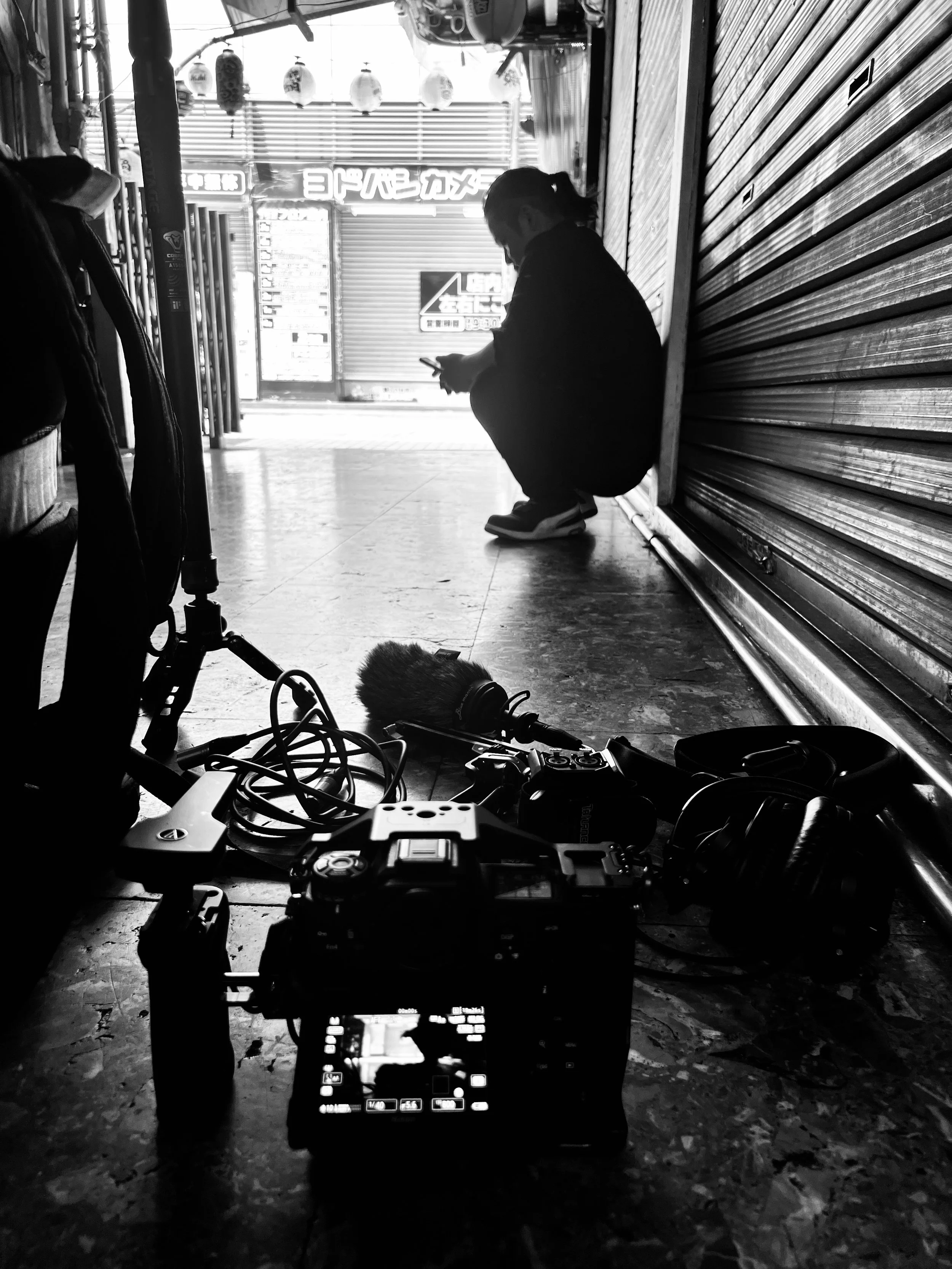 A man uses his phone in Ueno alley