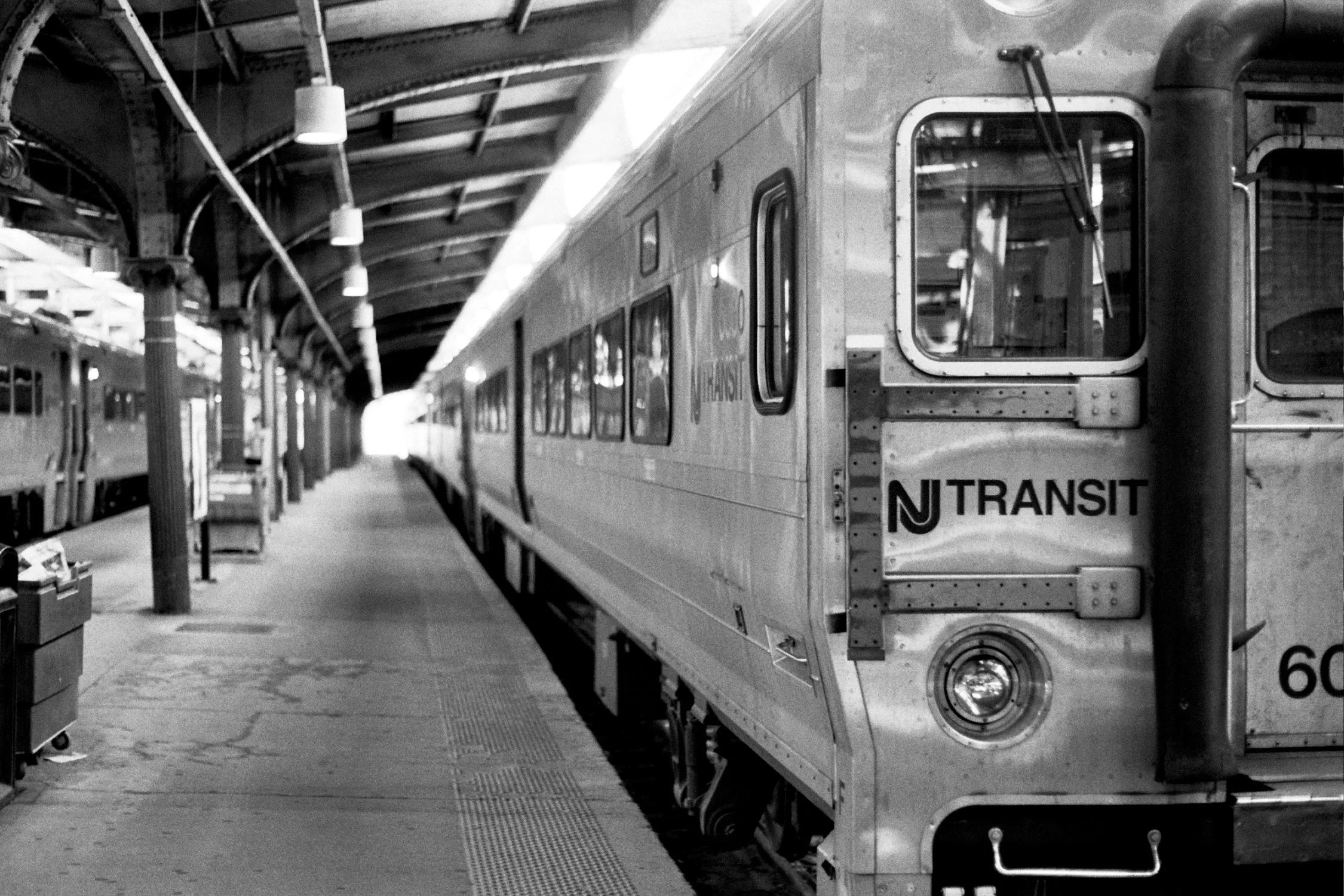 A train is pulled into the station. Another train is at the next platform, also stationary.
