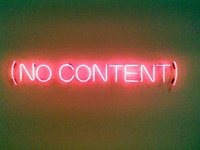 A neon sign is lit up in pink. It reads 'no content' in brackets.
