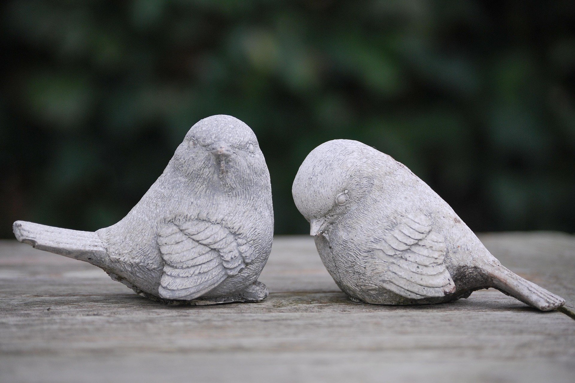 Two small birds made of stone.
