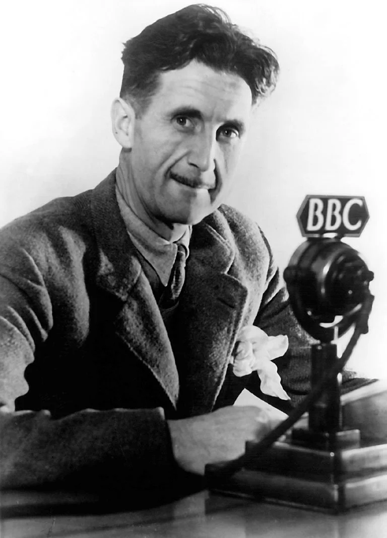 Author George Orwell sits at a BBC Radio microphone.