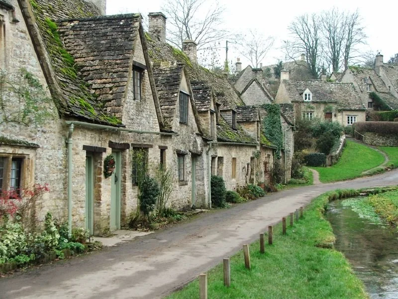 A street view of village houses in the Cotswolds, England.