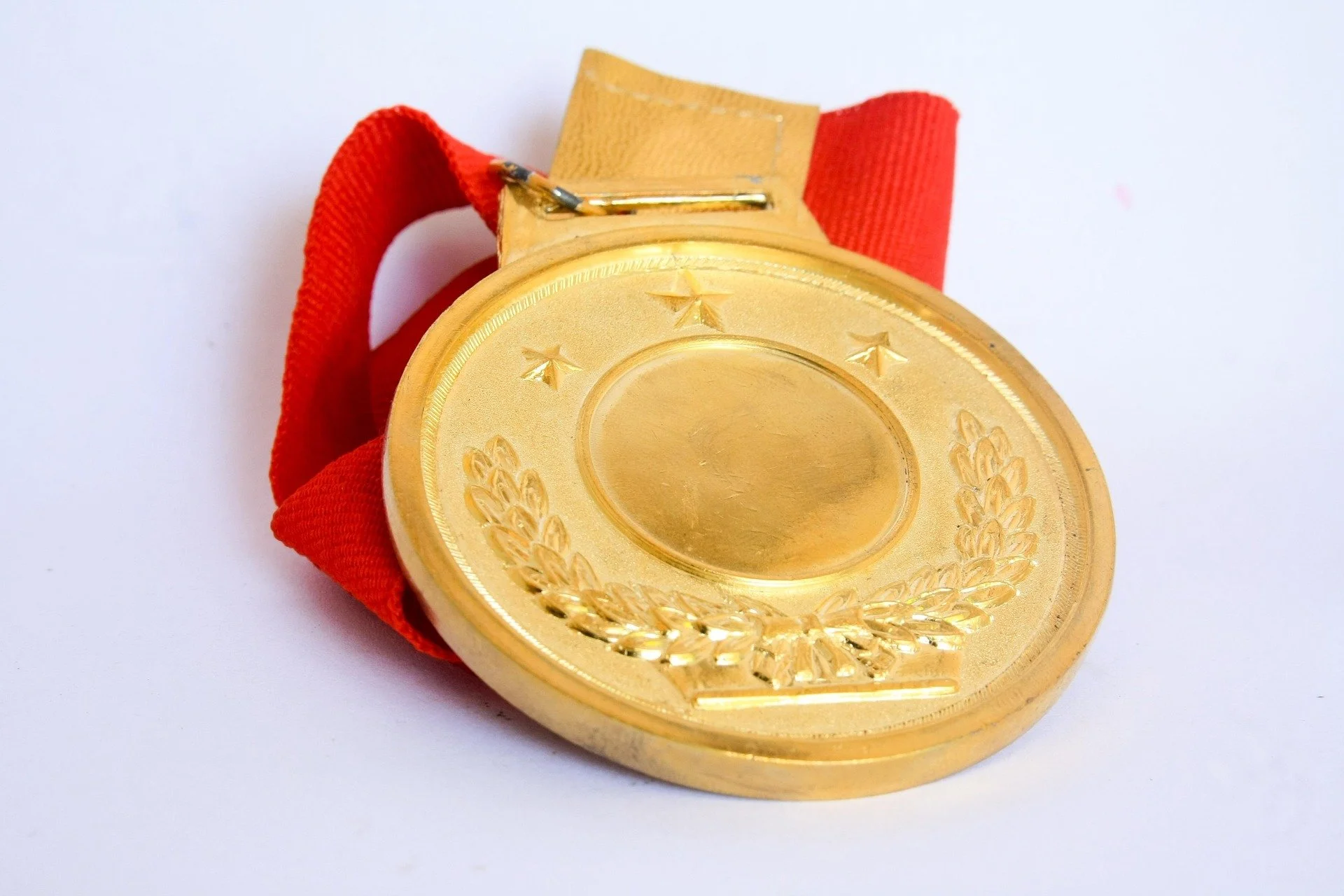 A gold medal with a red sash.