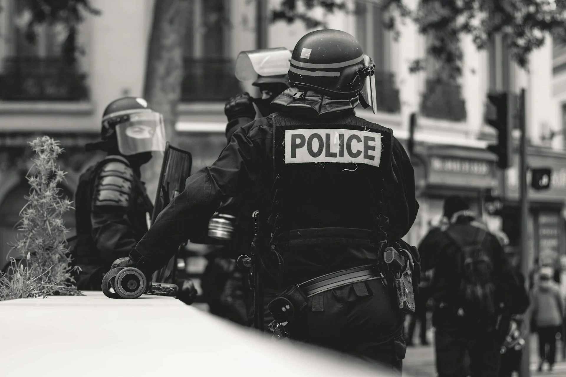 Three police officers take a break in a town square.