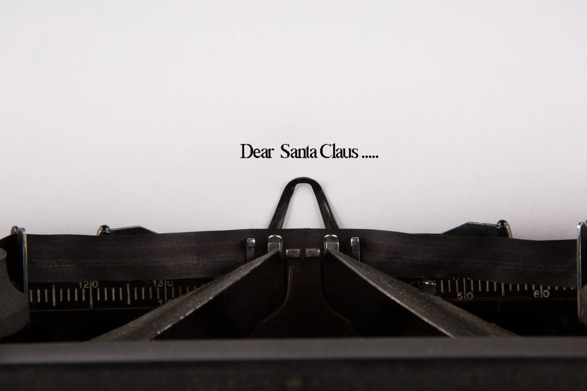 A page in a typewriters shows the words Dear Santa Claus.... typed on it.