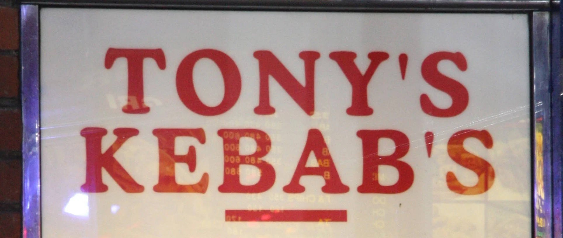 A shop sign reads Tony's kebab's, with an apostrophe unnecessarily placed before the s in kebabs.