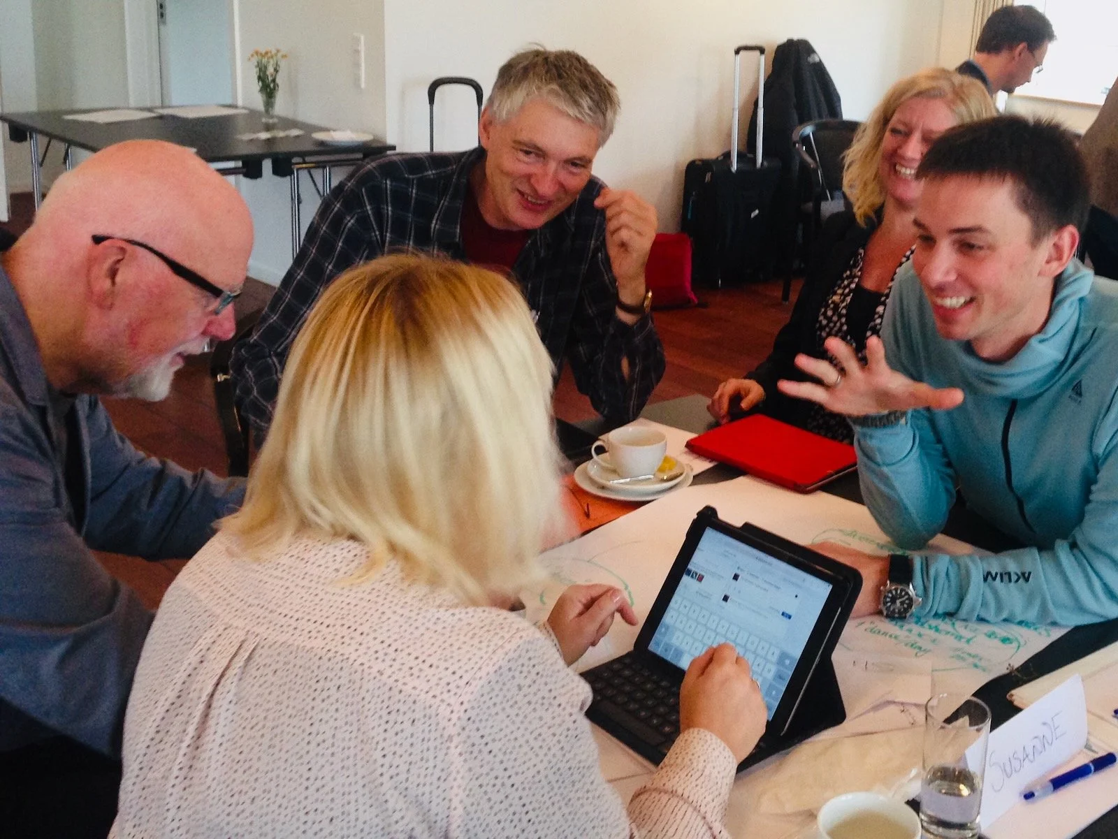 Workshop participants gathered around a table brainstorming pro-social behaviors