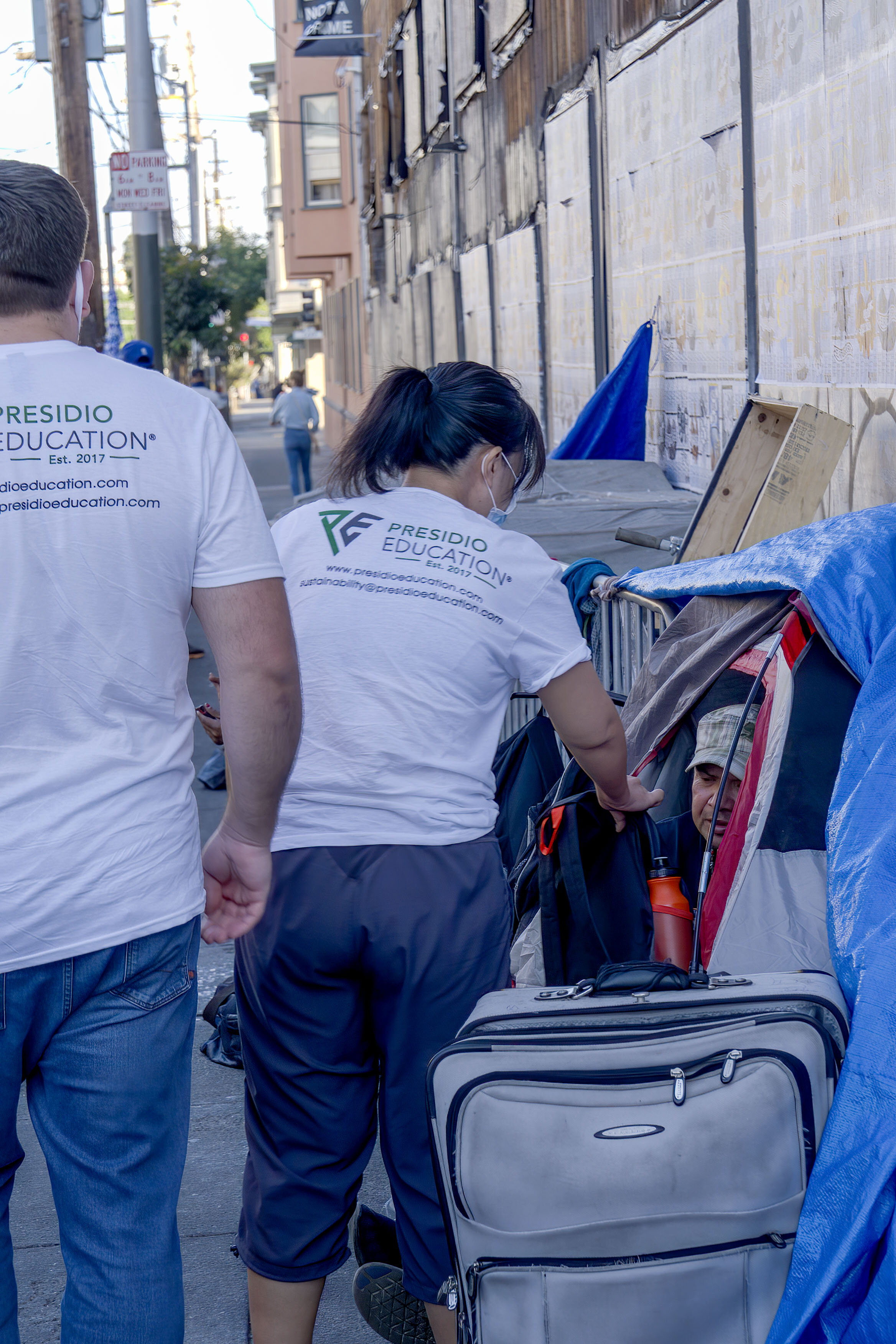  Giving out backpacks to the homeless in tents on Mission Street. Photograph by  Martin Nobida, English Teacher , 2020. 