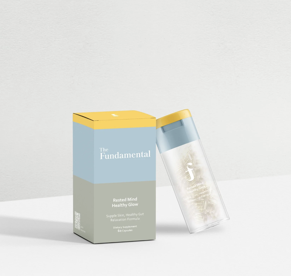 A box labeled 'The Fundamental Rested Mind Healthy Glow' diet supplement with 60 capsules, next to a transparent water bottle with a yellow lid.
