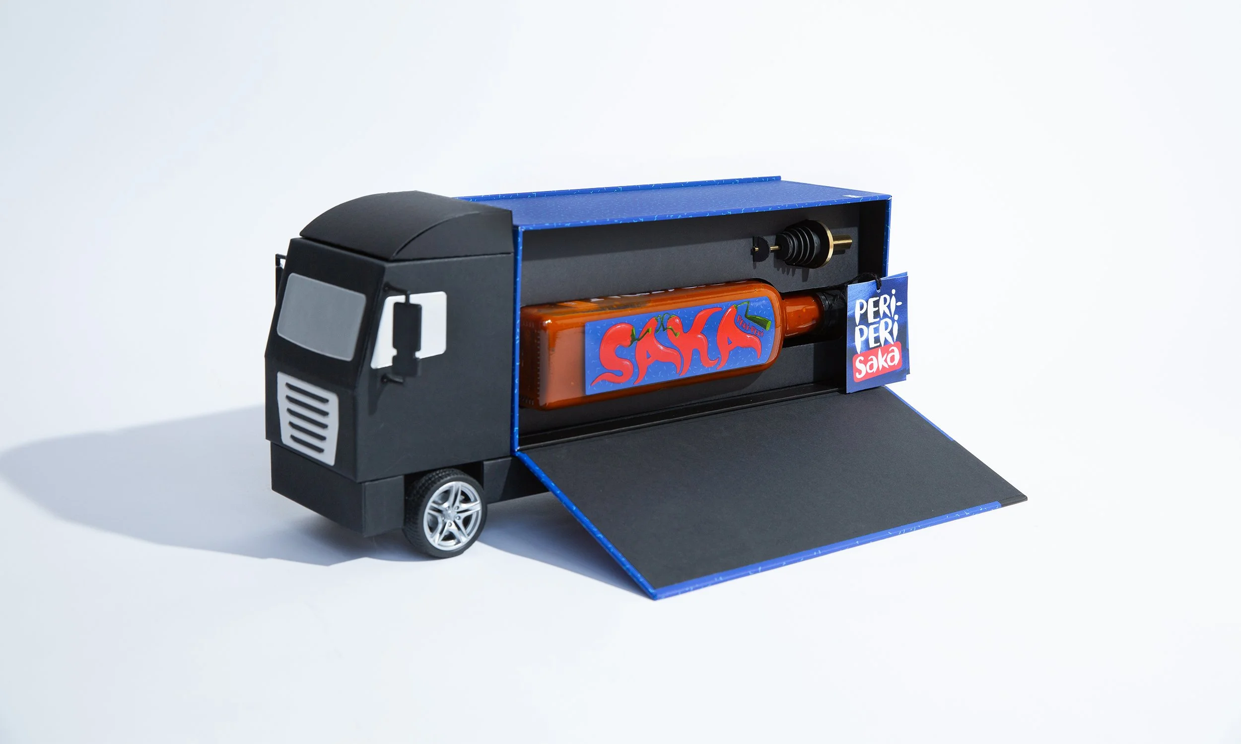 Bespoke gift box shaped like a lorry containing Nando's sauce.