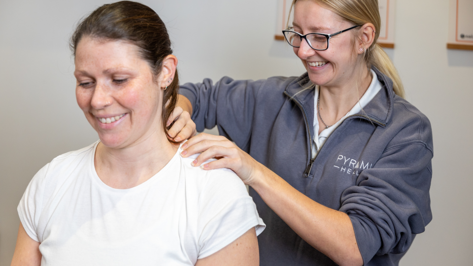 A woman receives massage to her neck