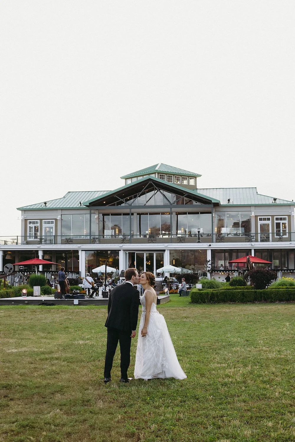 The bride and groom share a kiss infront of The Liberty House.