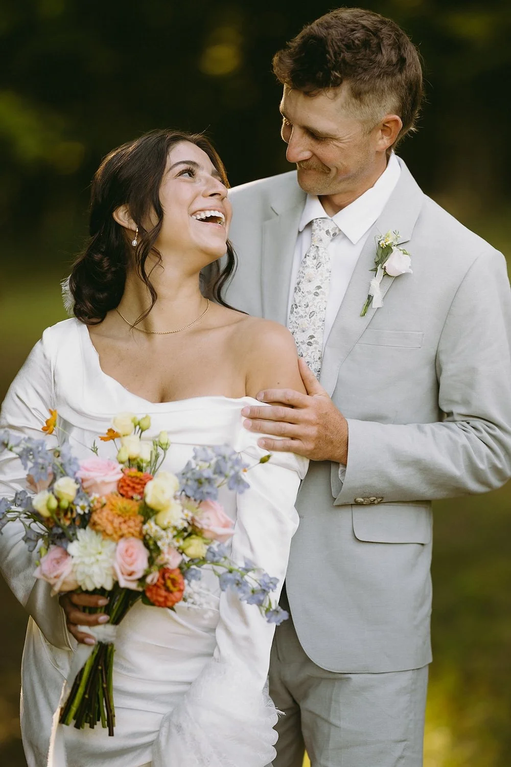 The bride looks back at her groom with a smile.