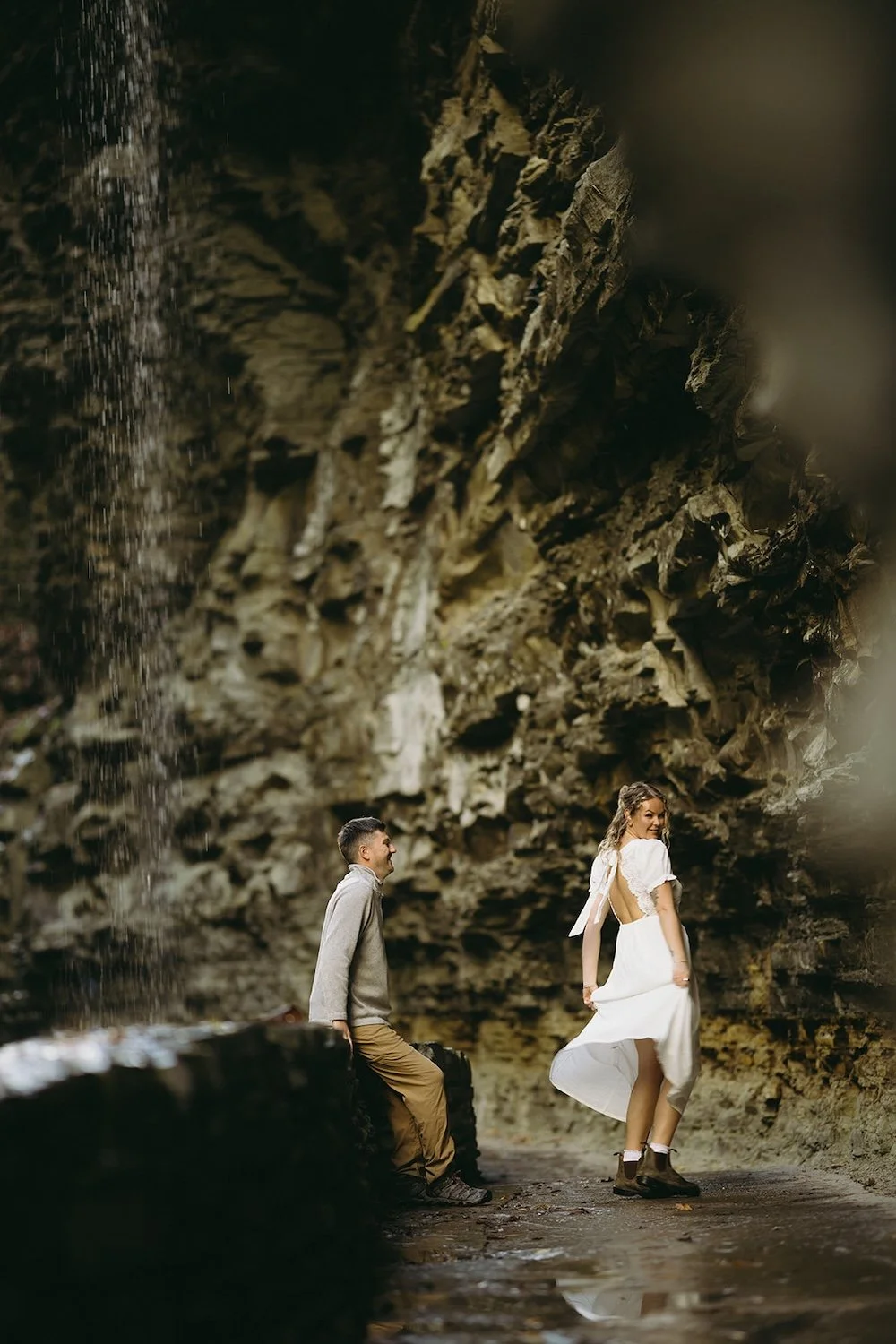 The future bride spins in circles holding her dress as she shows off for her future groom.