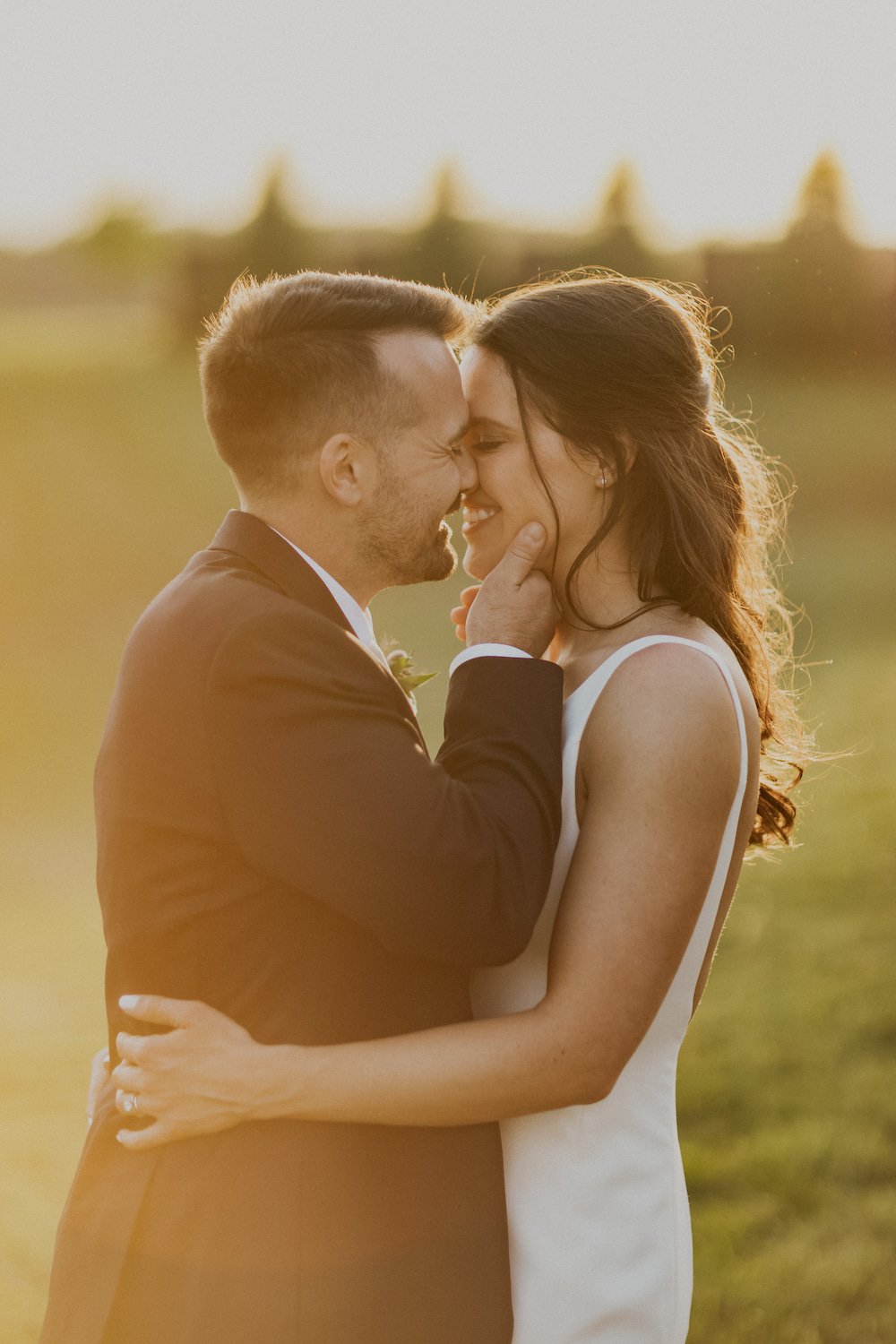 Bride and Groom share a kiss during golden hour photos.