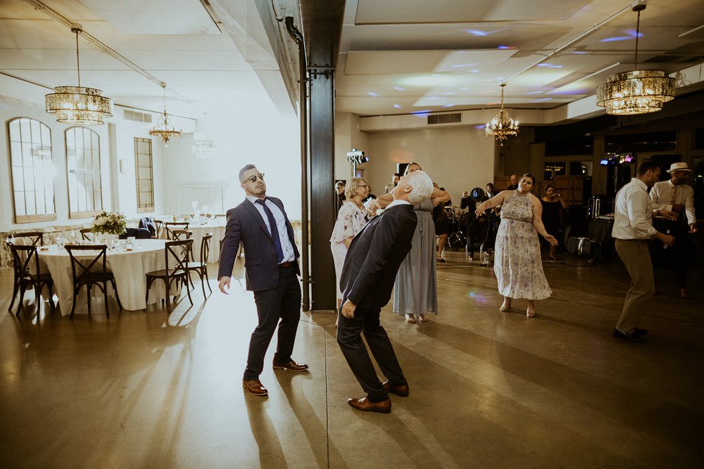 Guests pose for photo while dancing wearing sunglasses.