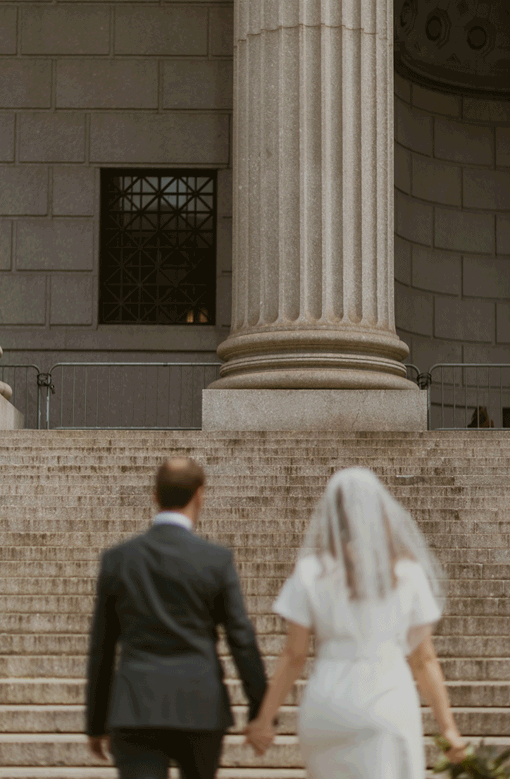The happy couple walk up the stairs to the courthouse to prepare for their elopement ceremony.