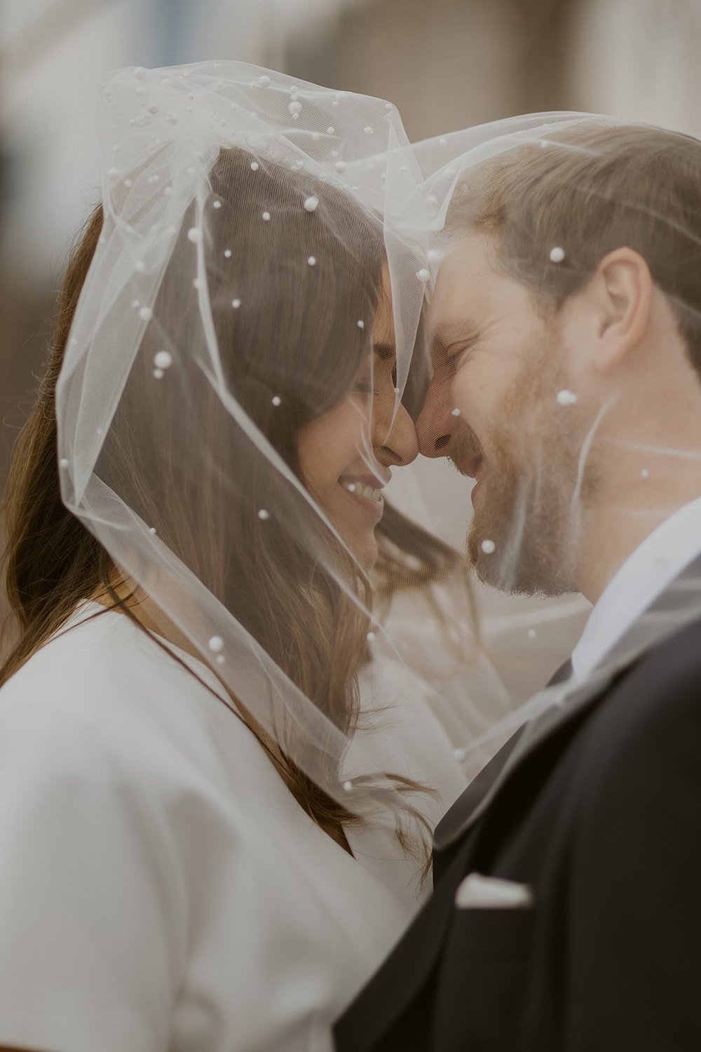 The couple share a moment together under her pearl veil.