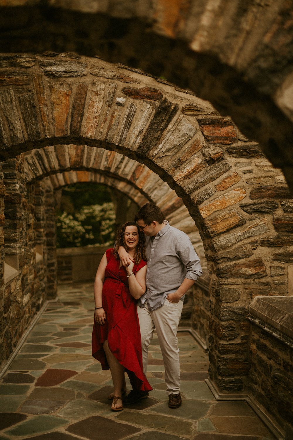 Couple close together in the beautiful archway of the church