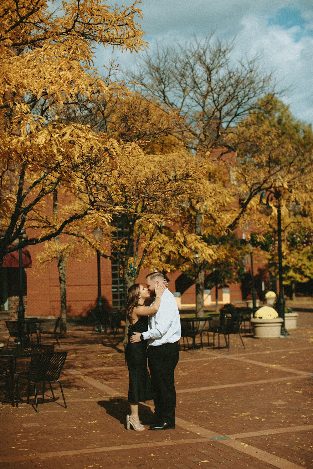 Couple standing in the middle of Market St. enjoying the fall foliage.