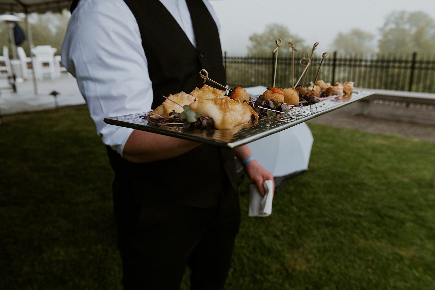 Server passing out Hors D'oeuvre to the wedding guests.
