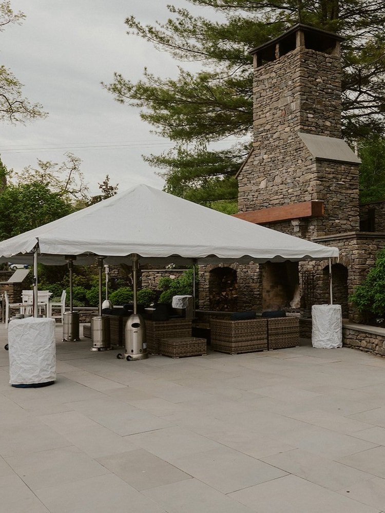 Tent outside of the Inns of Taughannock covering the patio and fire pit. 