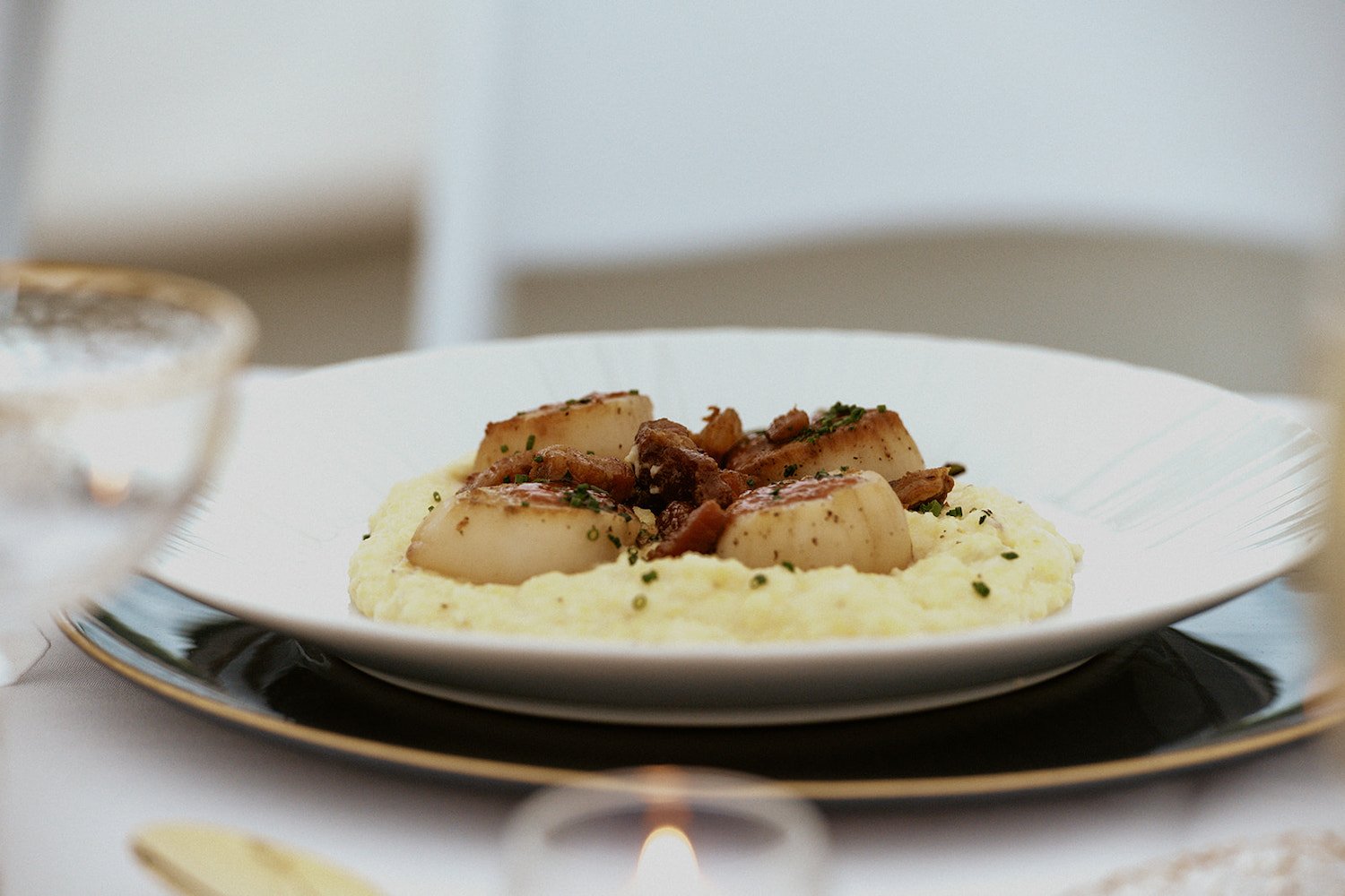Scallops over a bed of mashed potatoes.