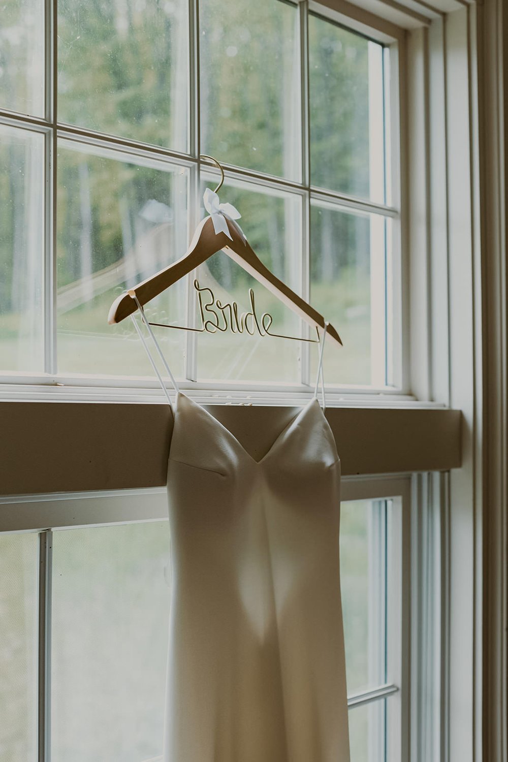 Bridal gown hanging with her bride hanger. 