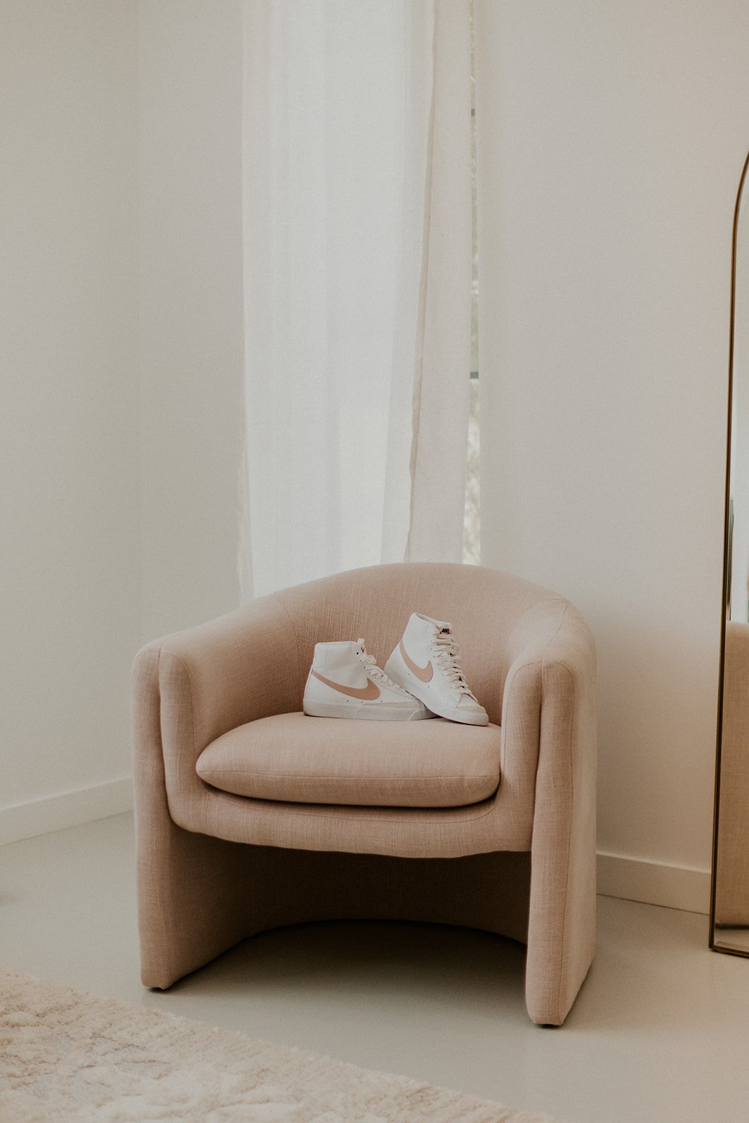 The brides dancing sneakers on a lounge chair in the bridal suite.