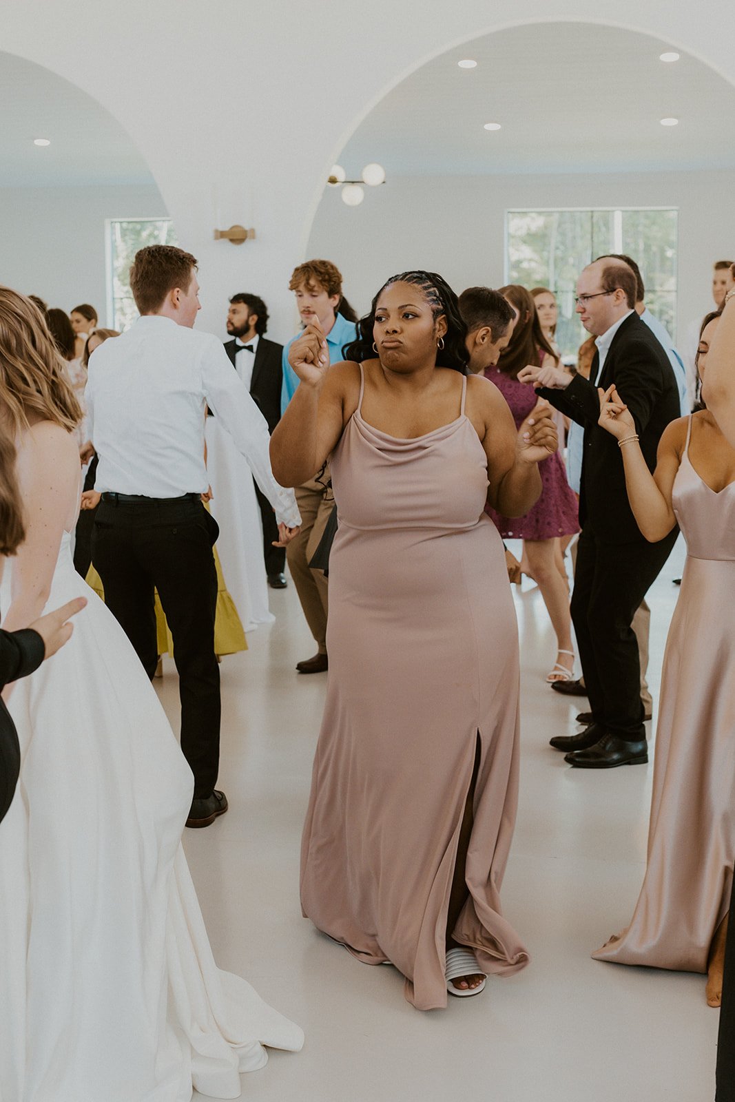 Bridesmaid enjoys a dance with her other bridesmaids.
