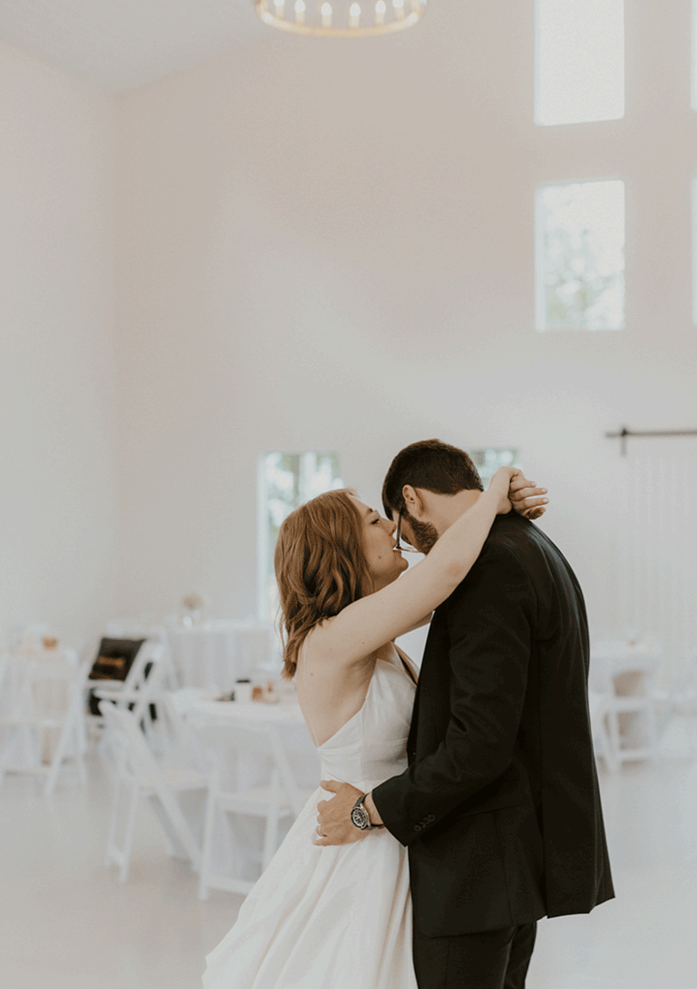 Bride shares a secret with her groom while dancing during their private last dance together.