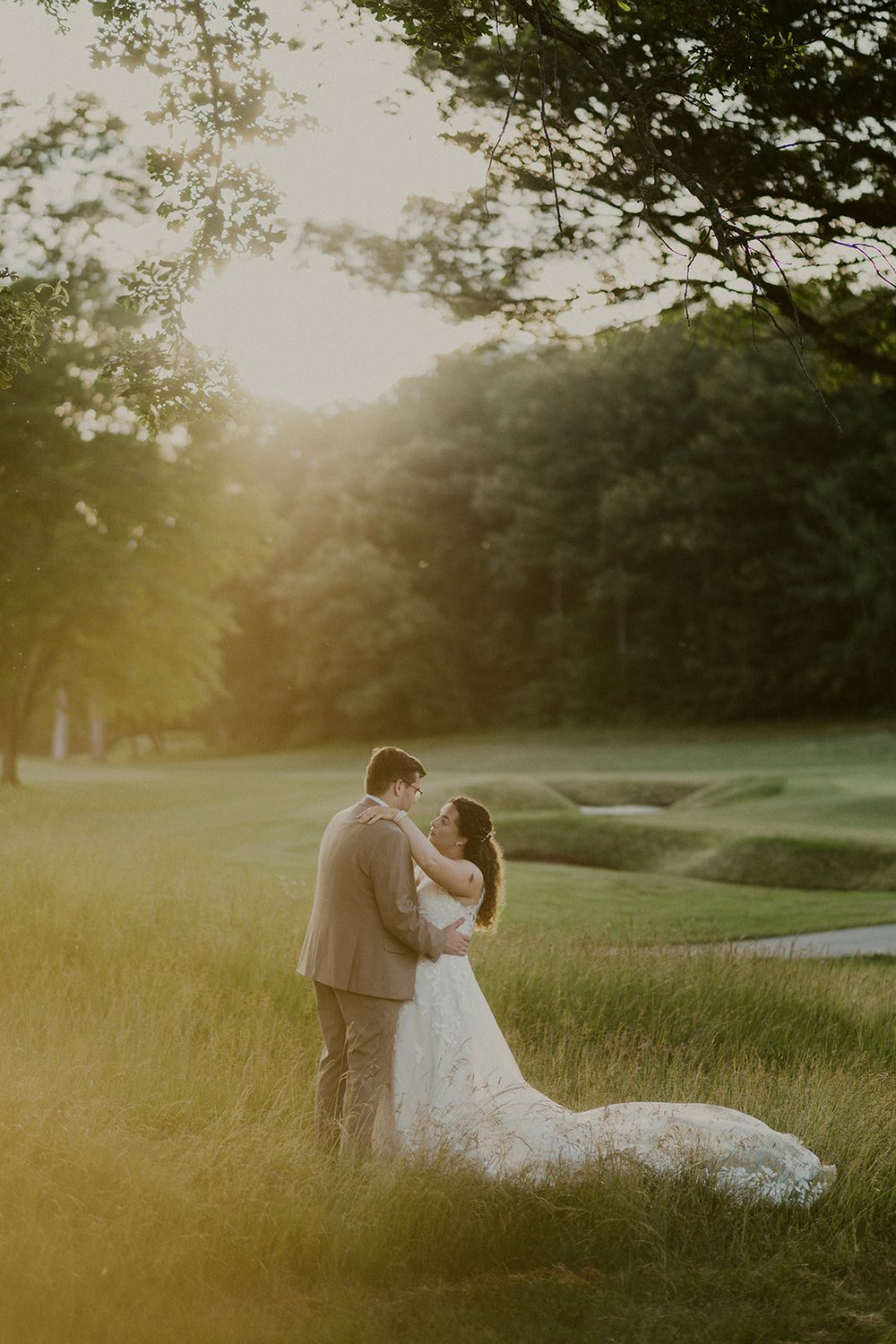 Bride and groom sharing a moment next to a tree on Corning Country Club Golf Course.