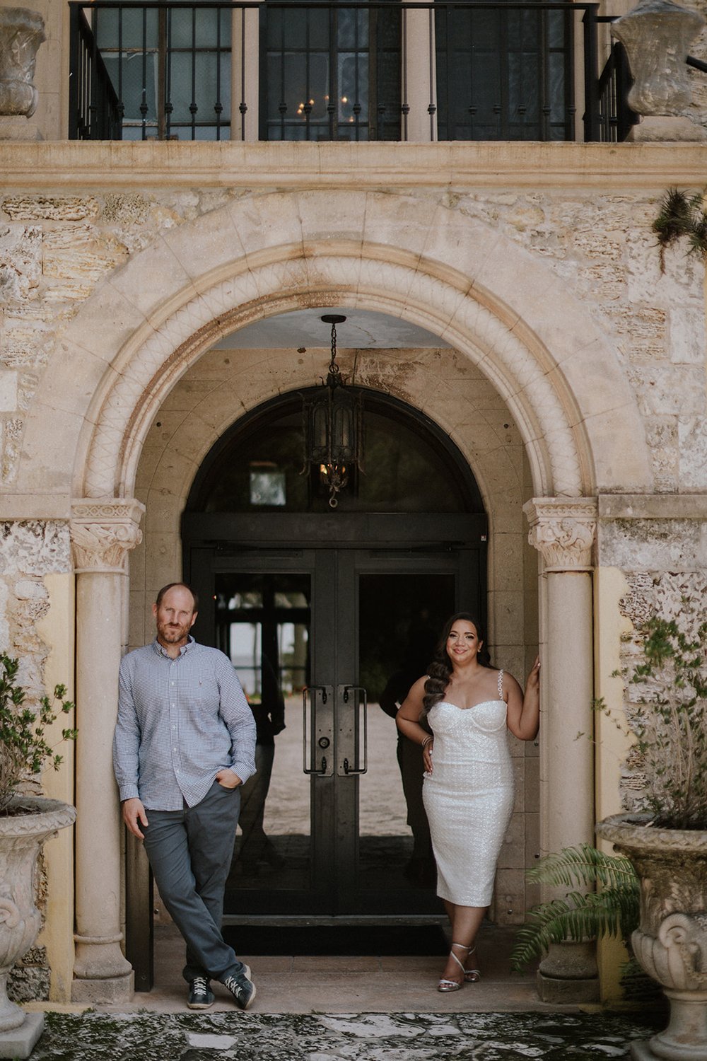Couple standing in the archway of the Deering Estate.