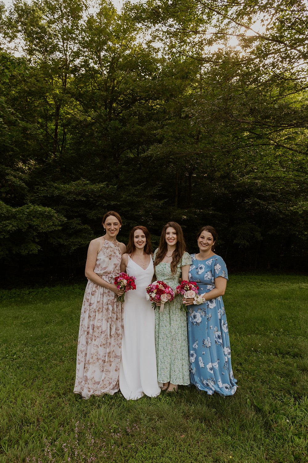 Bridesmaids pose together with smiles.