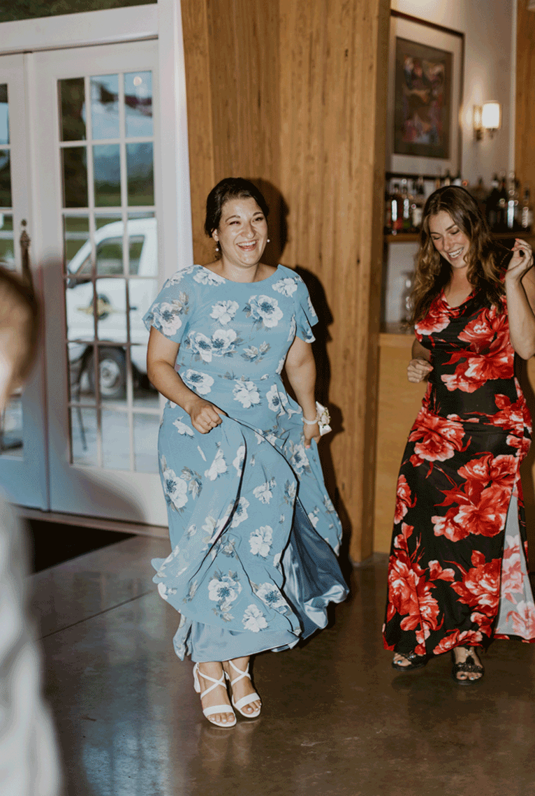 Bridesmaid dances with family.