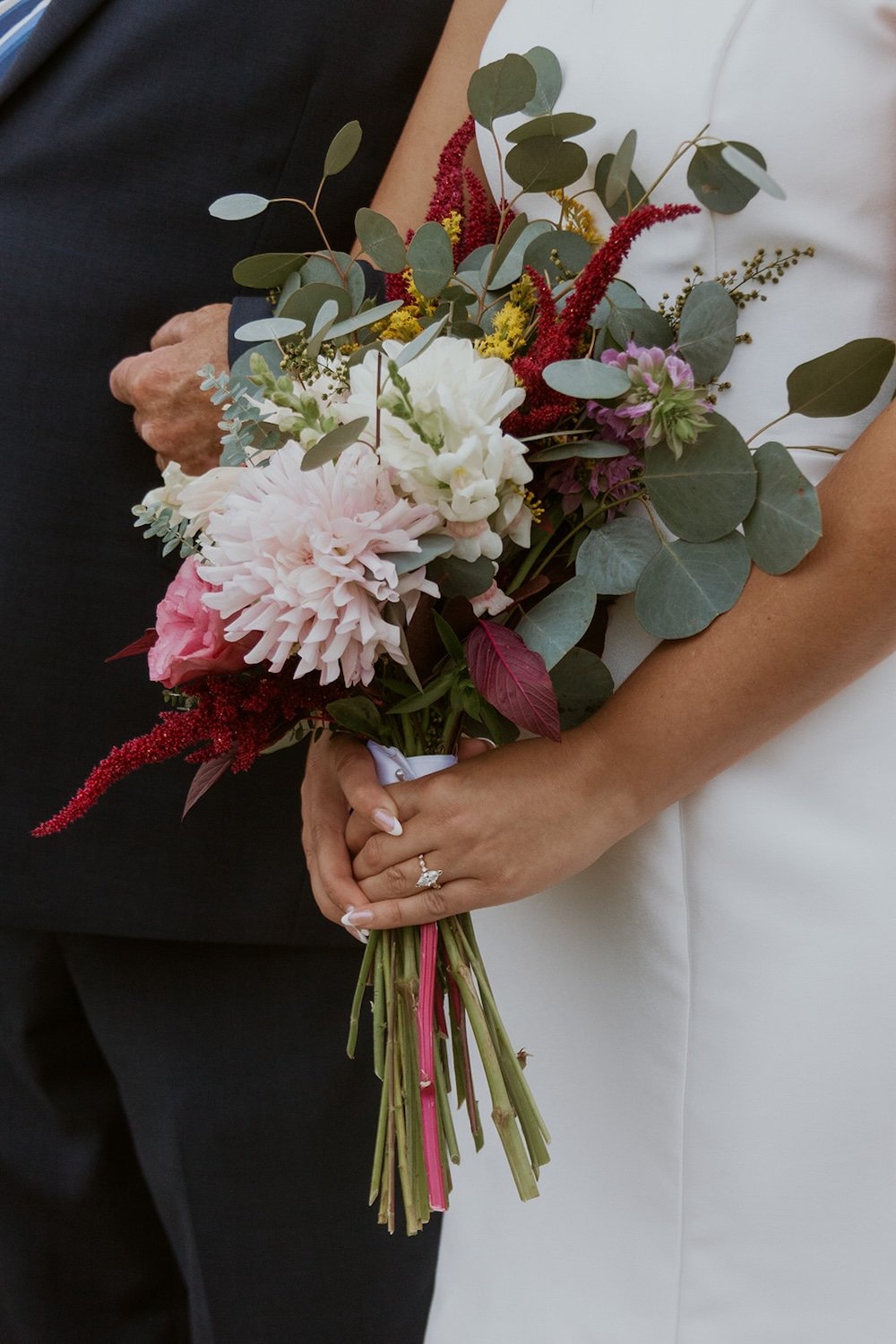 The bouquet decorated with bright pink, fuchsia and white florals.  