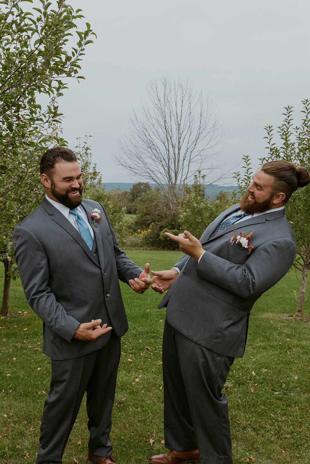 The groom and his best man laughing with one another.