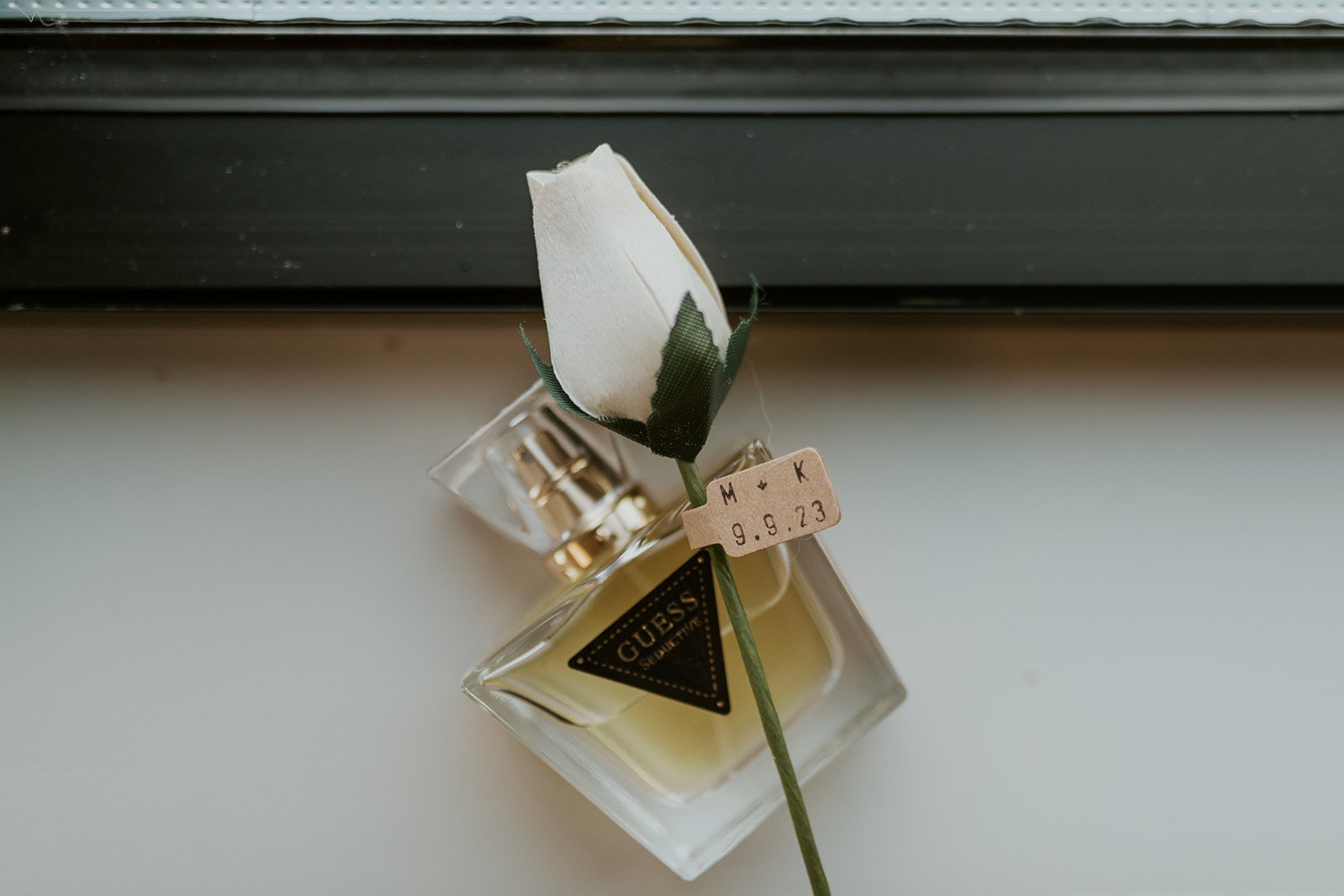 The bridal perfume and one white rose. 