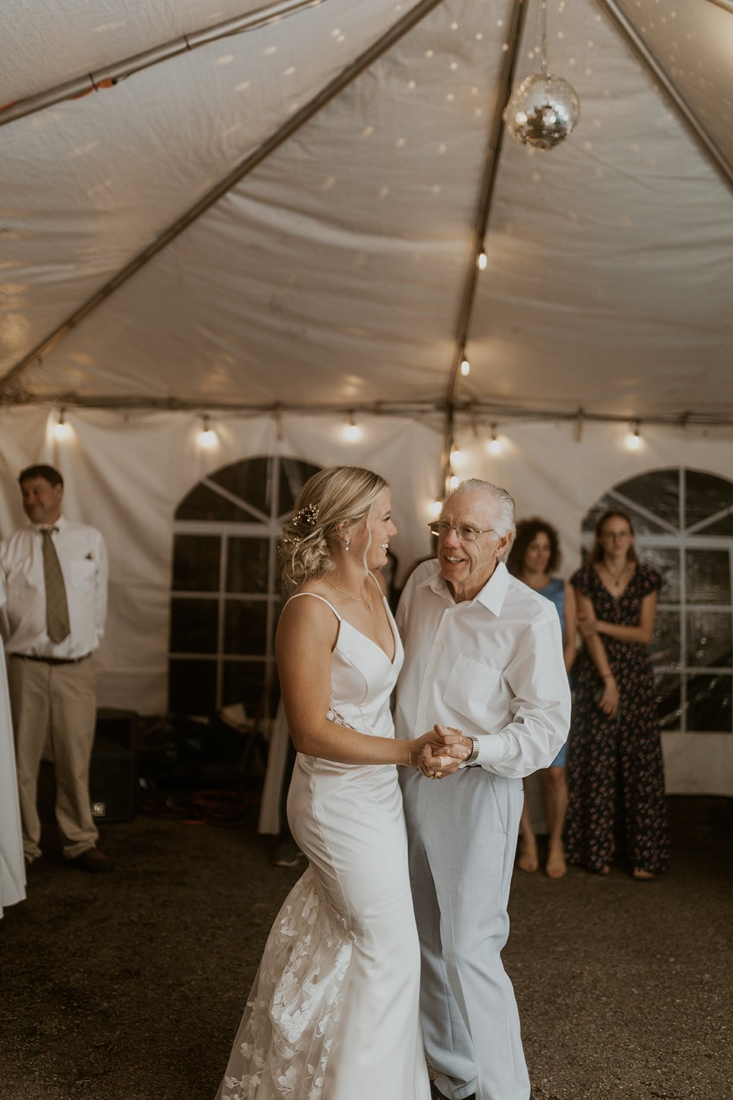 Bride dances with one of her guests. 