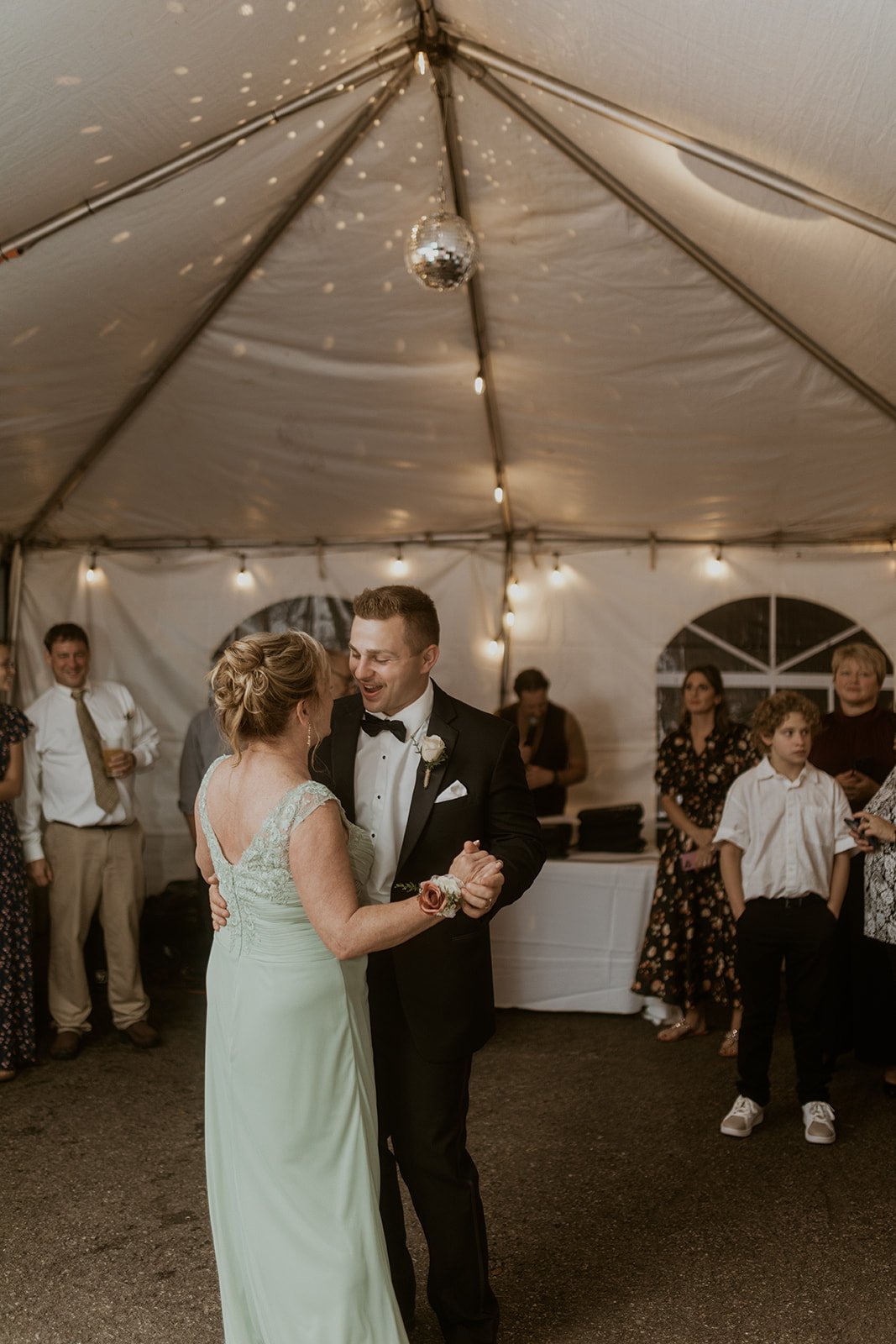 Groom dances with one of his guests during their reception. 
