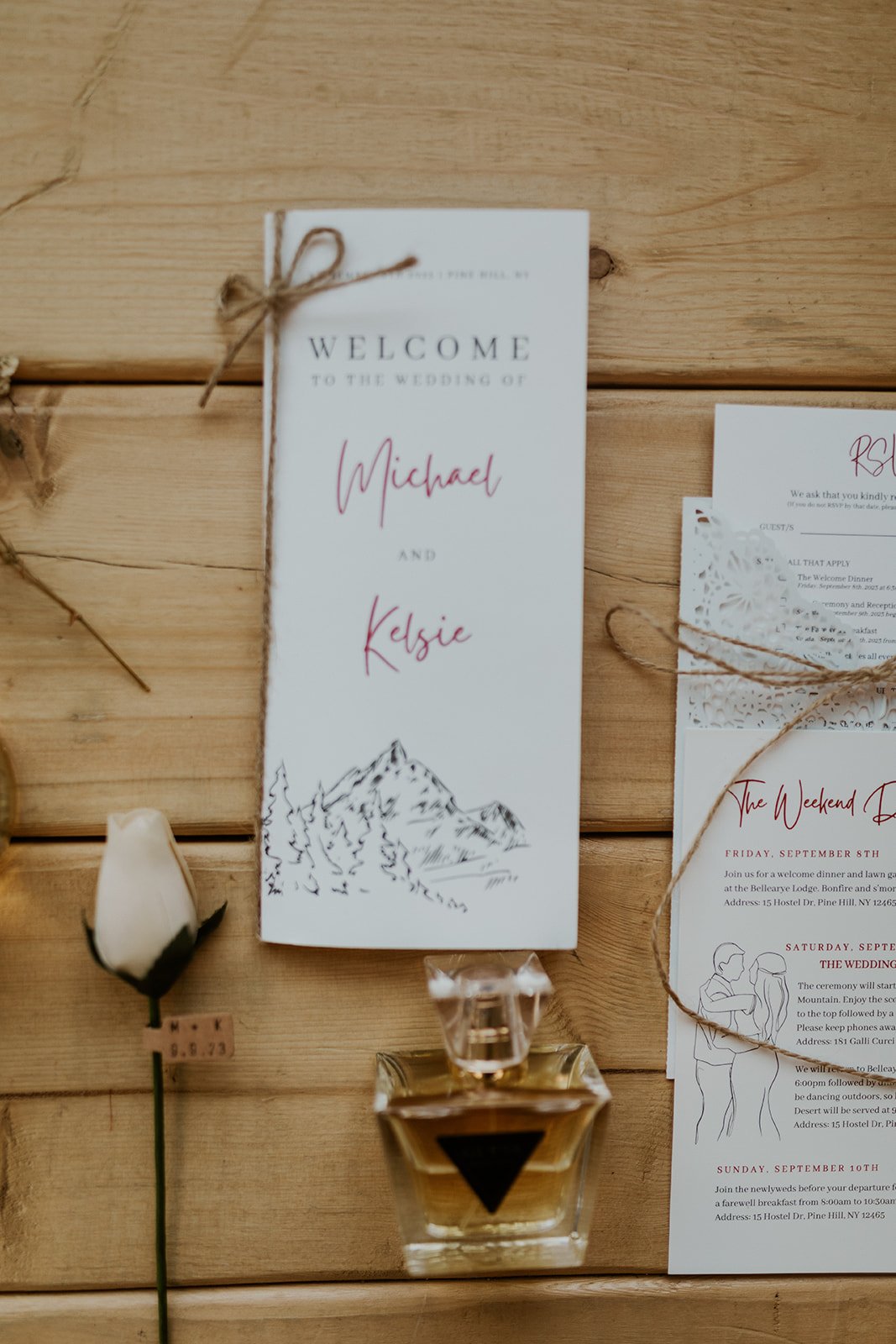The wedding stationary with a oak background dressed with a rose and the brides signature scent. 