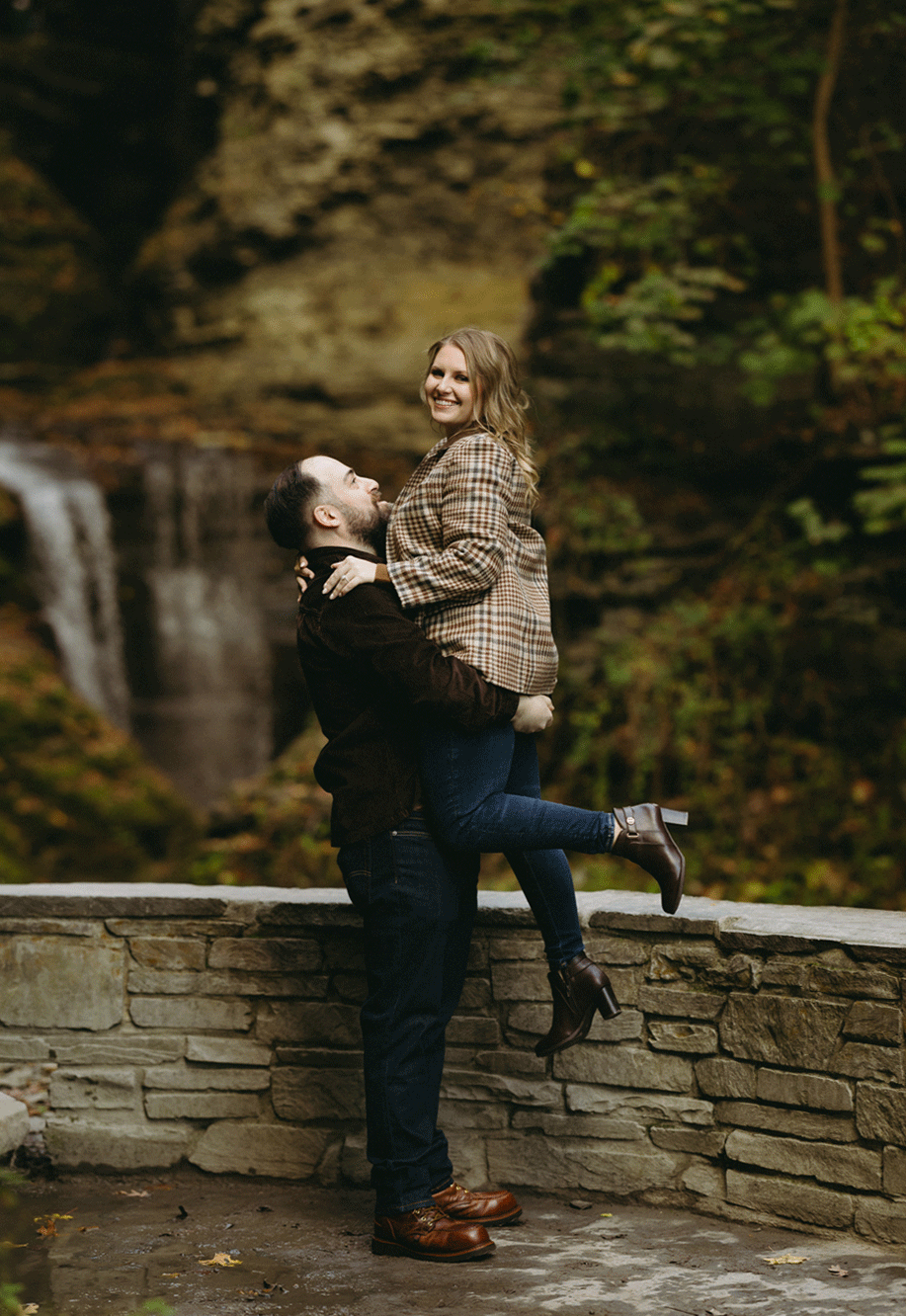 The future groom holding his future bride while smiling. 
