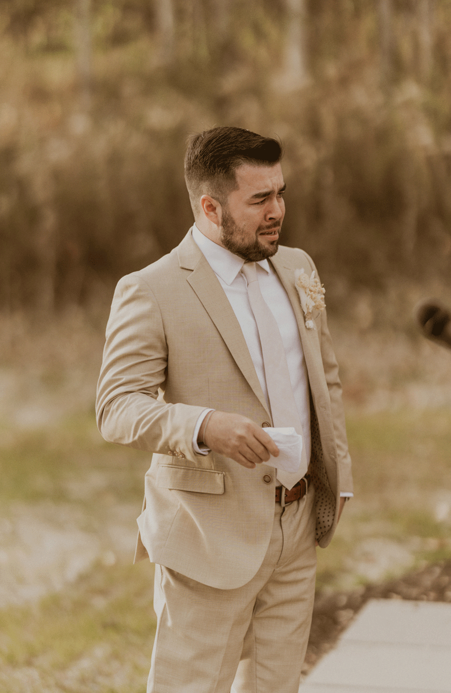 Live photo of the groom shedding a tear at the wedding ceremony.