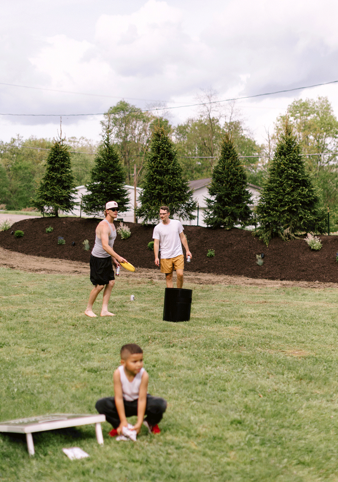 Groomsmen play outdoor games together before the wedding ceremony.