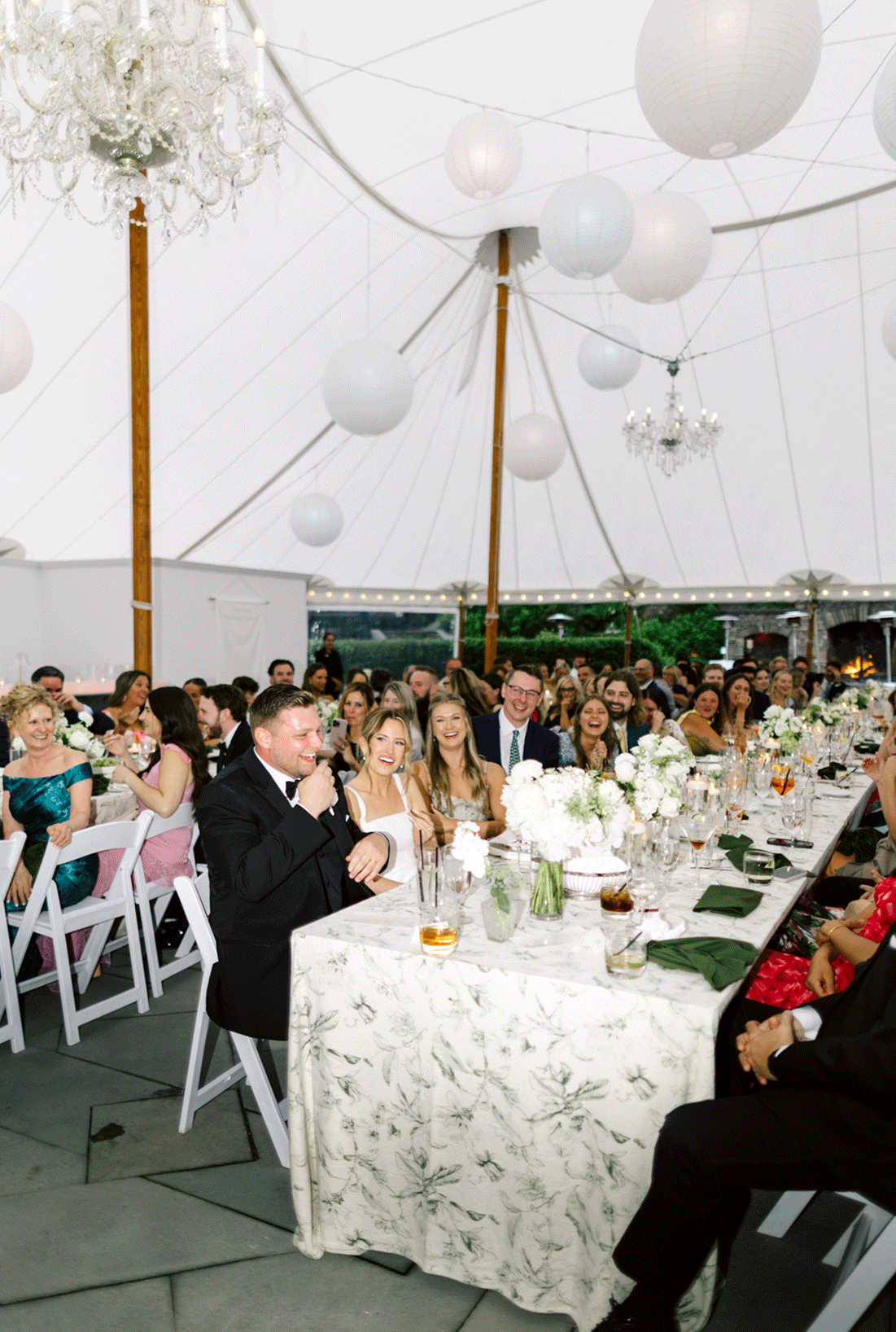 Live photo of the guests laughing during the speeches. 