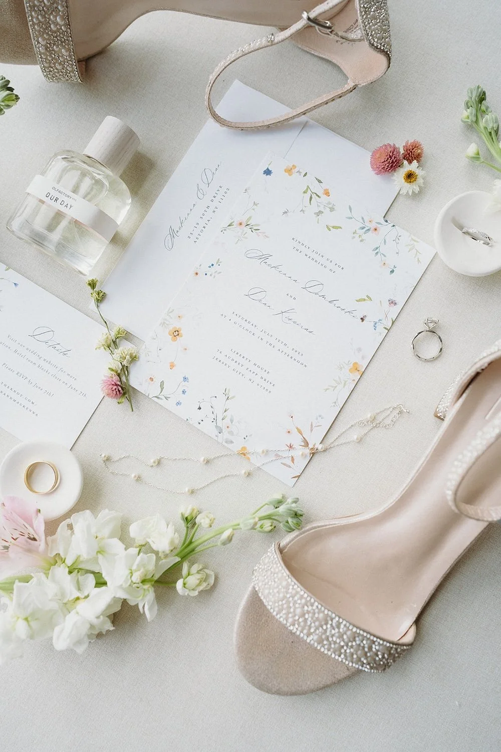 Detail photo of the brides wedding day items. The wedding stationary, brides shoes, florals and signature perfume. 