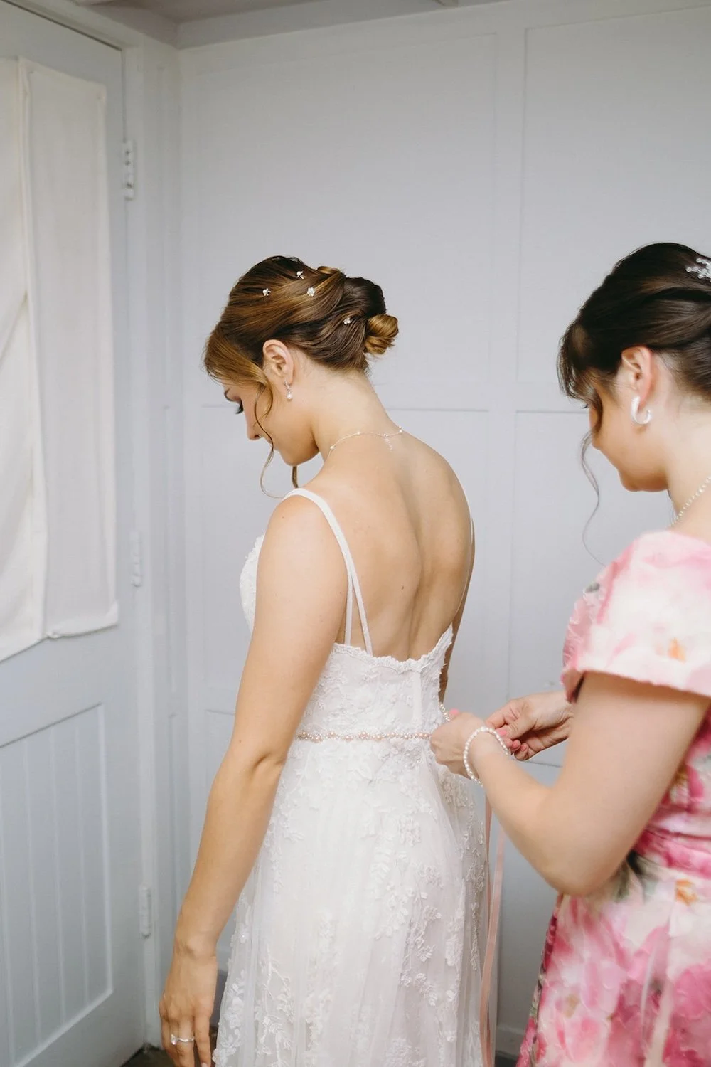 Family button's the brides wedding gown. 