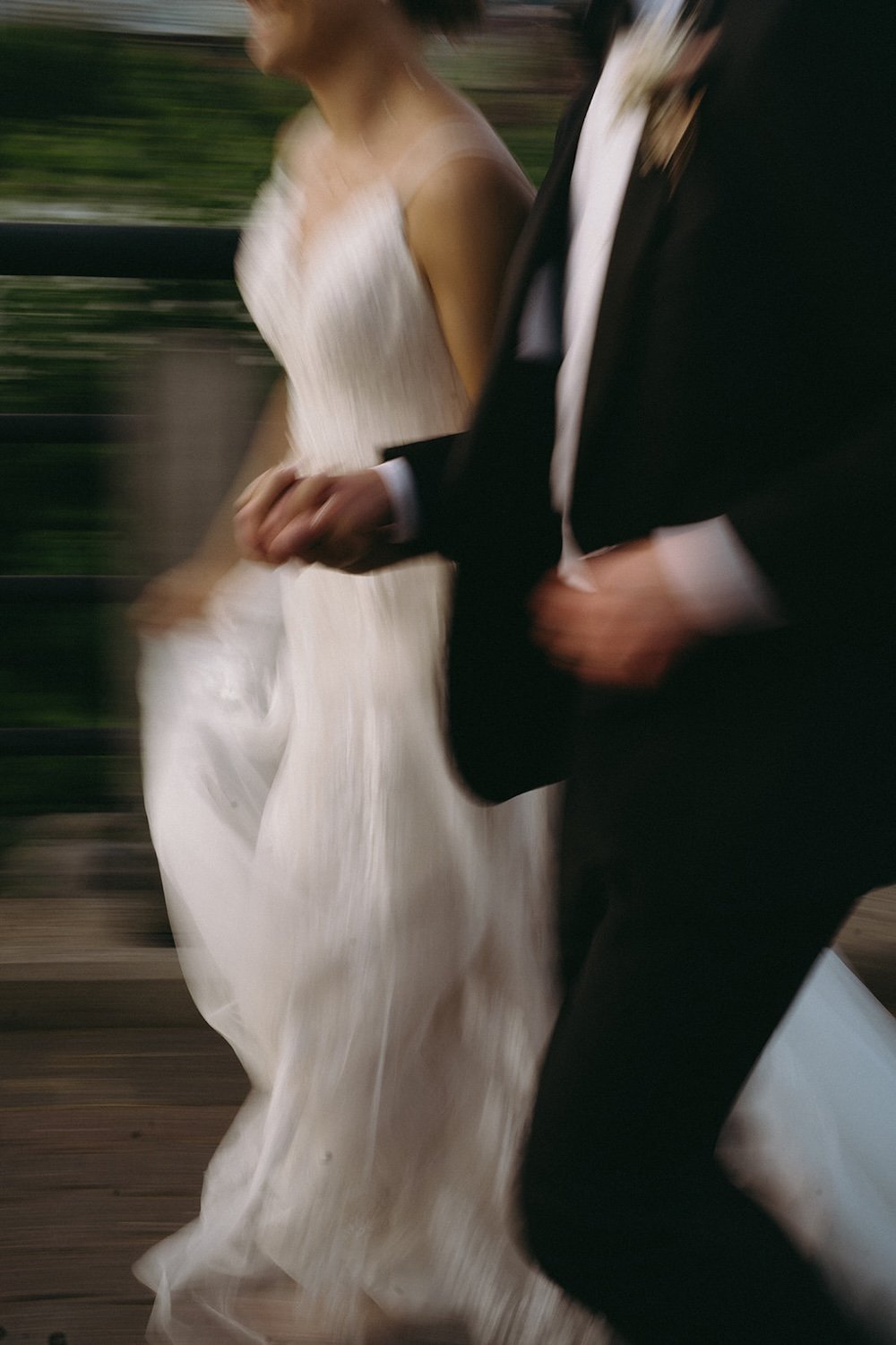 Blurred photo of the couple hand-in-hand running together. 