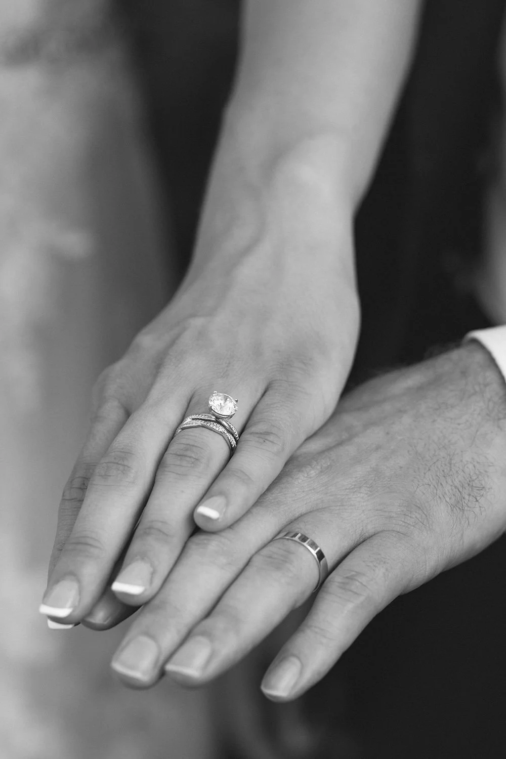 Black and white photo of the bride and grooms wedding bands. 