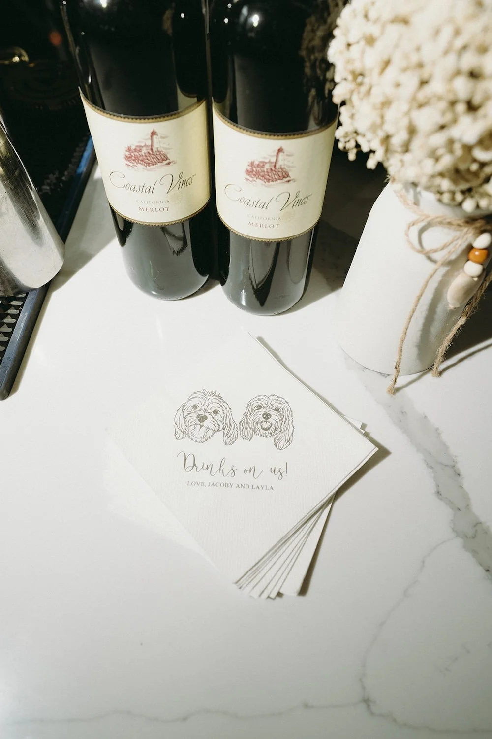 Bottles of wine and the wedding cocktail napkins.